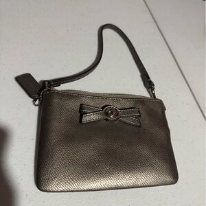 Elegant Coach Metallic Wristlet with Bow Accent